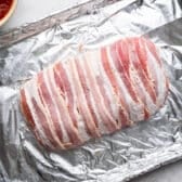 Meatloaf wrapped in bacon before it goes in the oven.