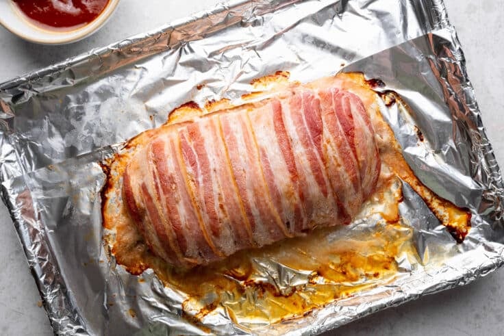 Bacon wrapped meatloaf after its first time in the oven.
