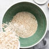 Adding oats to the bowl to soak.