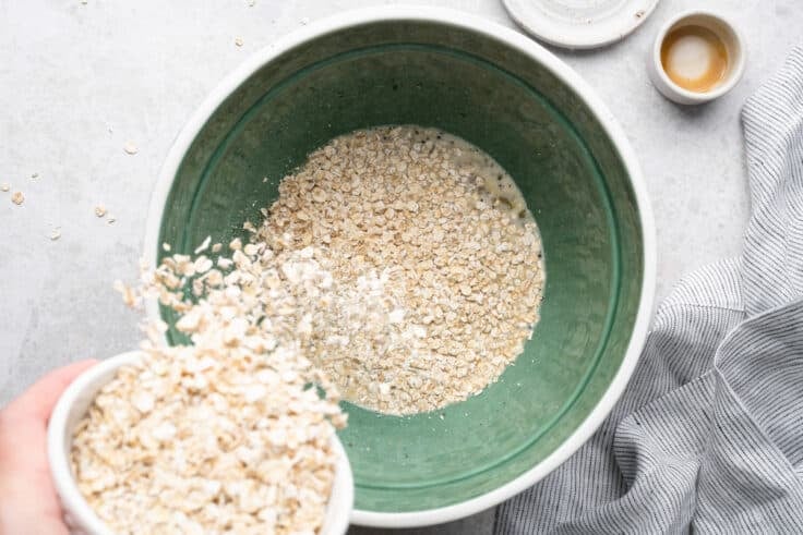 Adding oats to the bowl to soak.